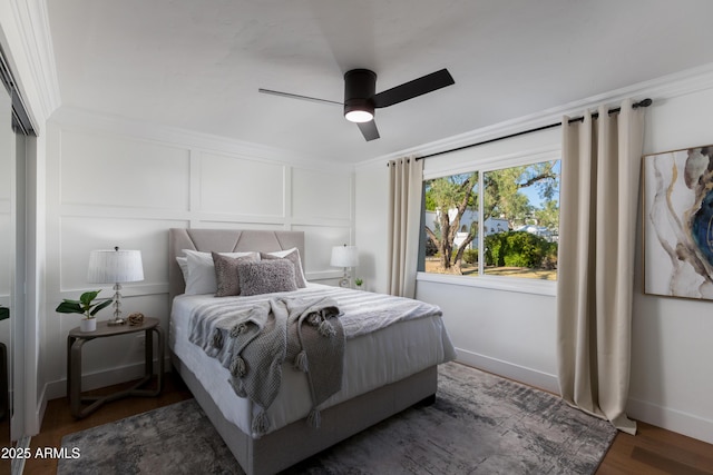 8317 E Orange Blossom Ln, Scottsdale, AZ 85250 - bedroom with wood finished floors, ceiling fan, and a decorative wall