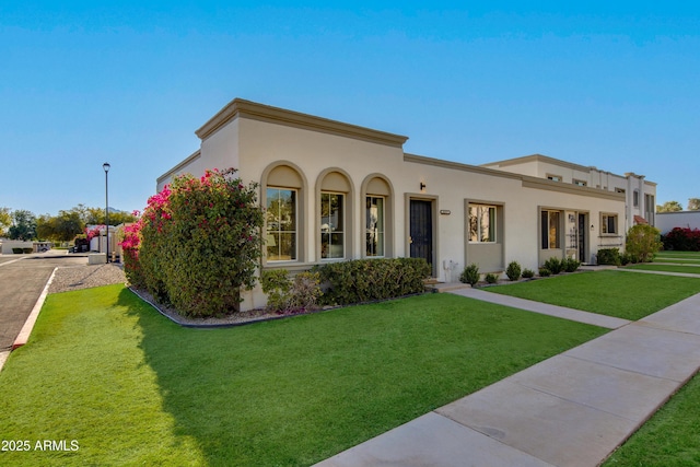 8317 E Orange Blossom Ln, Scottsdale, AZ 85250 - mediterranean / spanish home with stucco siding and a front yard