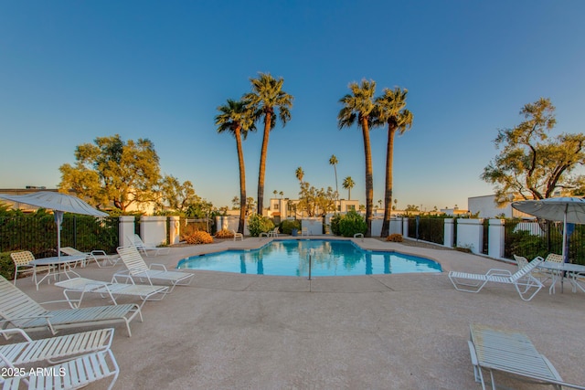 8317 E Orange Blossom Ln, Scottsdale, AZ 85250 - pool at dusk with a community pool and a patio area