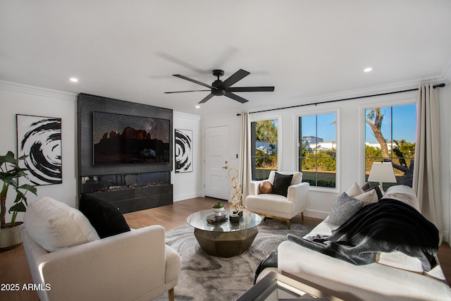 8317 E Orange Blossom Ln, Scottsdale, AZ 85250 - living area with ornamental molding, recessed lighting, wood finished floors, ceiling fan, and baseboards