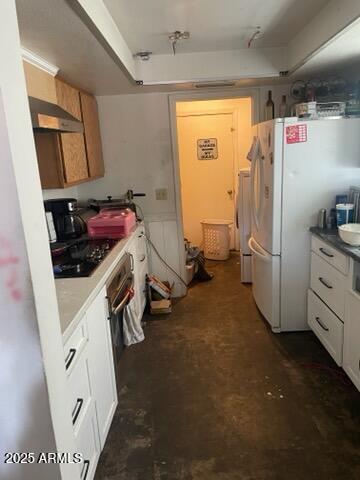 kitchen featuring wall oven, unfinished concrete floors, freestanding refrigerator, black electric cooktop, and ventilation hood