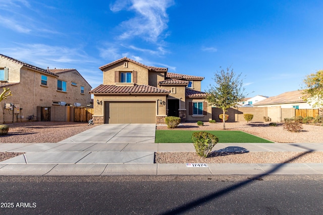 mediterranean / spanish house featuring driveway, a garage, stone siding, a tiled roof, and stucco siding