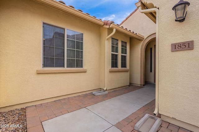 property entrance featuring a patio area