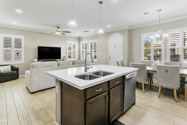 kitchen with sink, stainless steel dishwasher, a kitchen island with sink, and decorative light fixtures