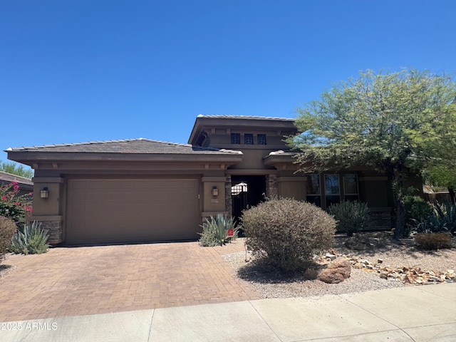 18008 W Ocotillo Ave, Goodyear, AZ 85338 - prairie-style house featuring an attached garage, decorative driveway, stucco siding, and a tiled roof