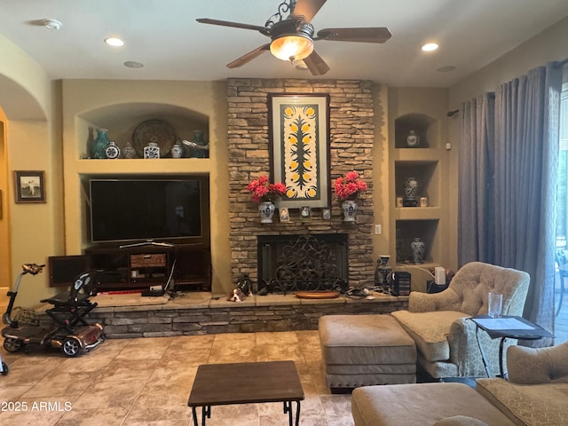 18008 W Ocotillo Ave, Goodyear, AZ 85338 - living room with a ceiling fan, built in features, a stone fireplace, and recessed lighting