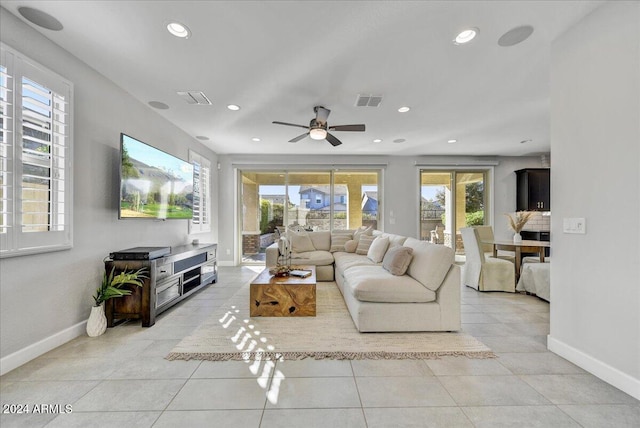 living room with ceiling fan and light tile patterned flooring