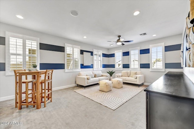 carpeted living room featuring ceiling fan