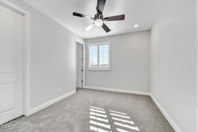 unfurnished bedroom featuring ceiling fan and light carpet