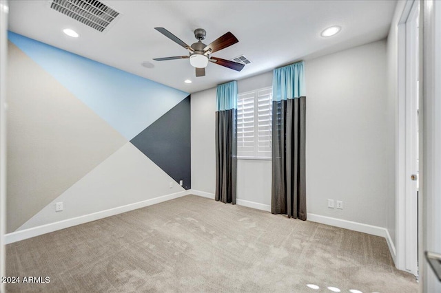 spare room with light carpet and ceiling fan