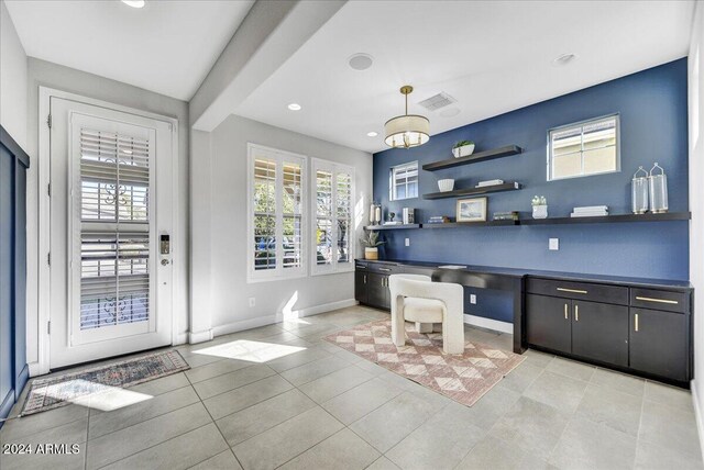 tiled office space featuring built in desk