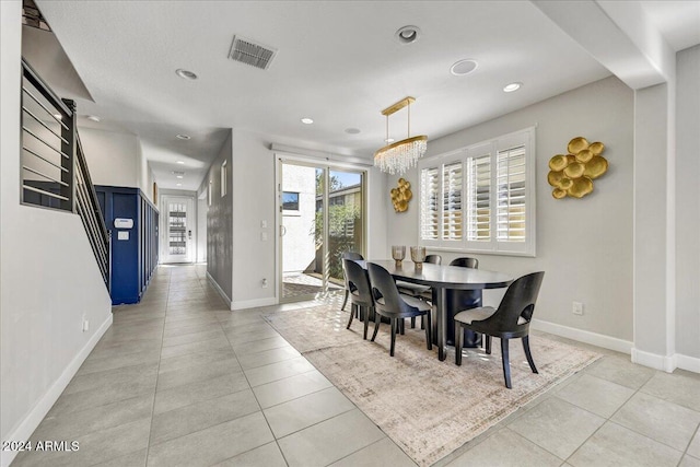 dining space featuring a chandelier and light tile patterned floors