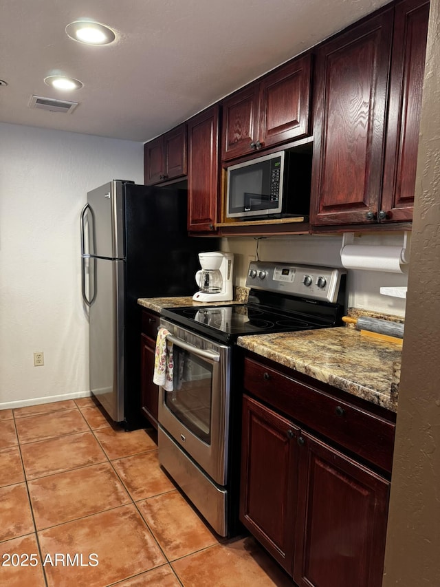 12123 W Bell Rd Unit 337, Surprise, AZ 85378 - kitchen featuring appliances with stainless steel finishes, light tile patterned flooring, and baseboards