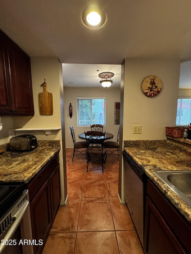 12123 W Bell Rd Unit 337, Surprise, AZ 85378 - kitchen with stainless steel dishwasher, light tile patterned floors, dark countertops, and plenty of natural light