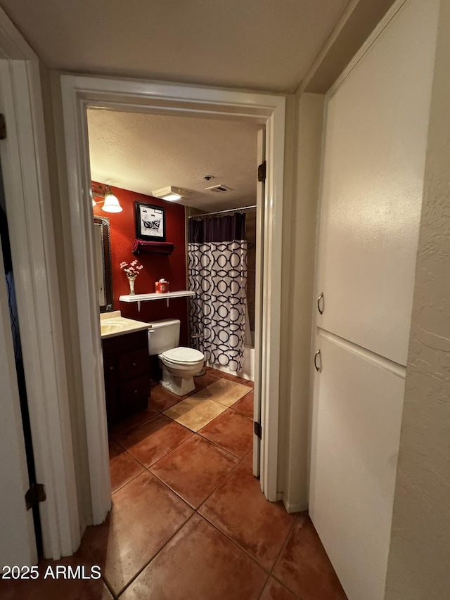 12123 W Bell Rd Unit 337, Surprise, AZ 85378 - full bath with tile patterned floors, toilet, vanity, and a textured ceiling