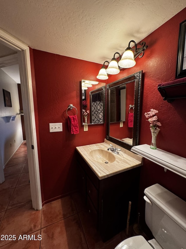 12123 W Bell Rd Unit 337, Surprise, AZ 85378 - bathroom with a textured wall, a textured ceiling, tile patterned floors, toilet, and vanity