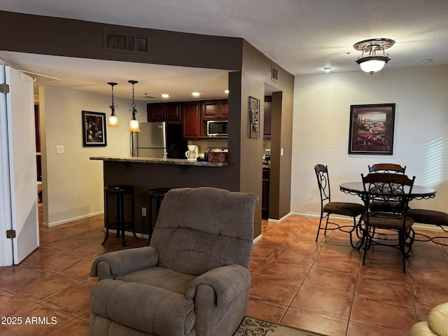 12123 W Bell Rd Unit 337, Surprise, AZ 85378 - dining room featuring light tile patterned flooring and baseboards