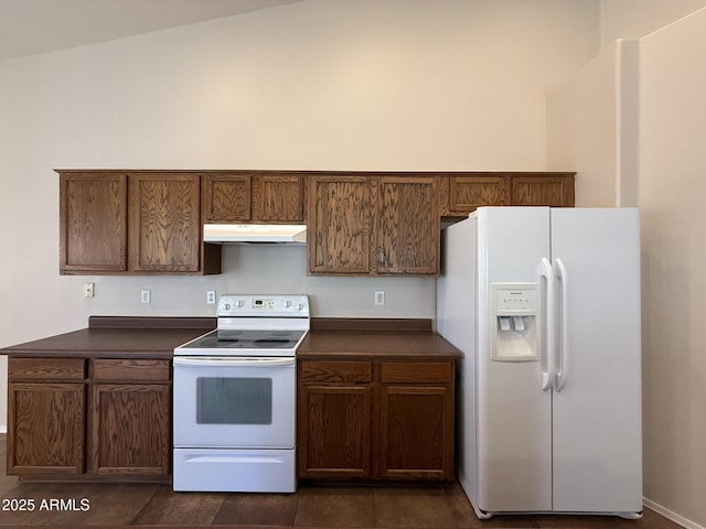 kitchen featuring dark countertops, white appliances, and under cabinet range hood