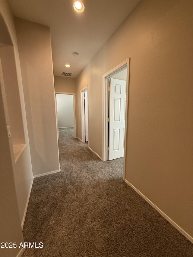 corridor featuring recessed lighting, carpet flooring, visible vents, and baseboards