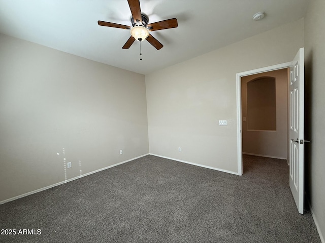 unfurnished room with dark carpet, baseboards, and ceiling fan