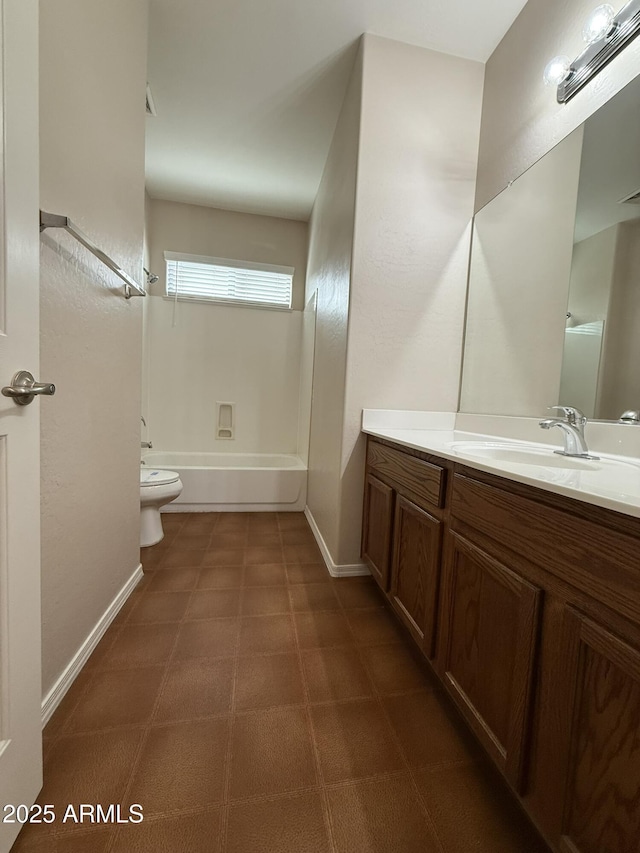 bathroom with baseboards, toilet, tile patterned floors, vanity, and shower / washtub combination