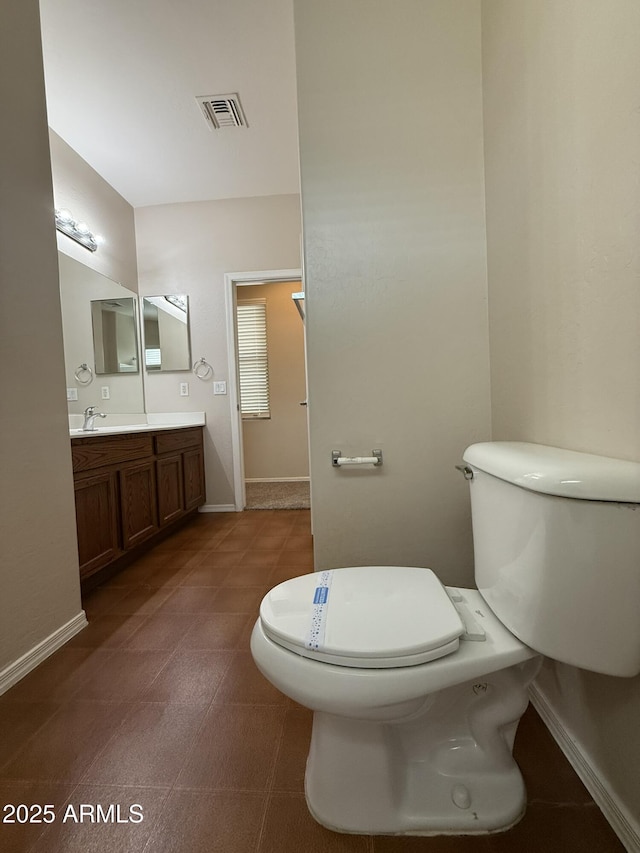 bathroom with toilet, baseboards, visible vents, and vanity