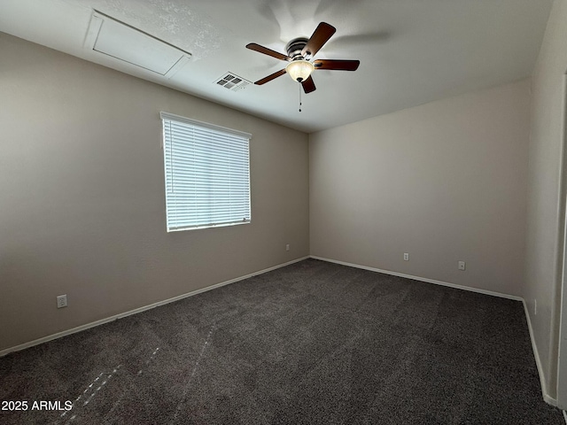 empty room featuring ceiling fan, baseboards, visible vents, and dark colored carpet