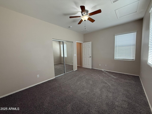 unfurnished bedroom featuring ceiling fan, a closet, baseboards, and carpet flooring