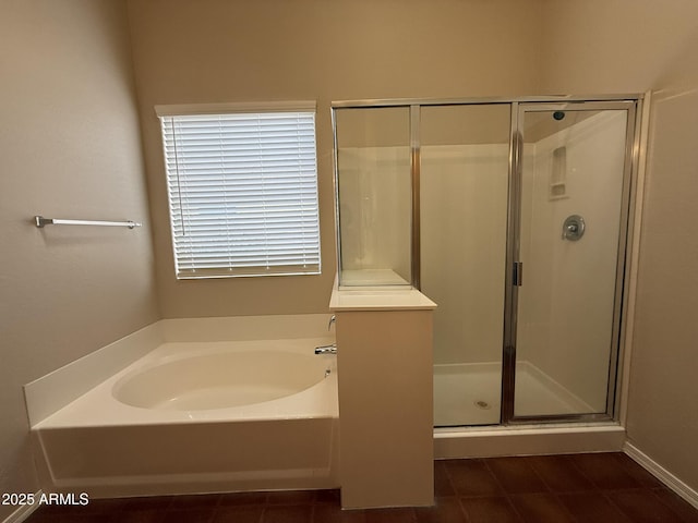 full bath with a stall shower and a garden tub