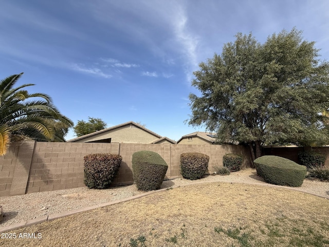 view of side of home featuring fence