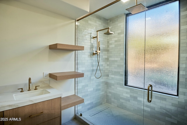 bathroom with vanity and a shower with door