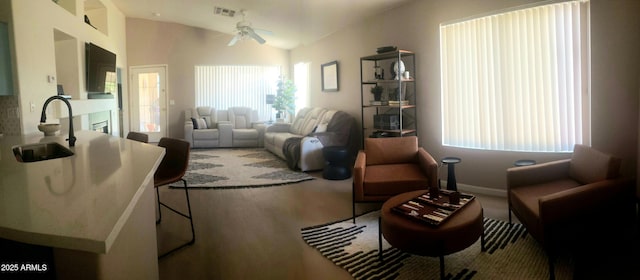 2004 N 108th Dr, Avondale, AZ 85392 - living area with a ceiling fan, plenty of natural light, wood finished floors, and lofted ceiling