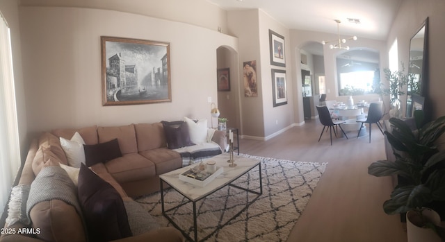 2004 N 108th Dr, Avondale, AZ 85392 - living area featuring arched walkways and wood finished floors