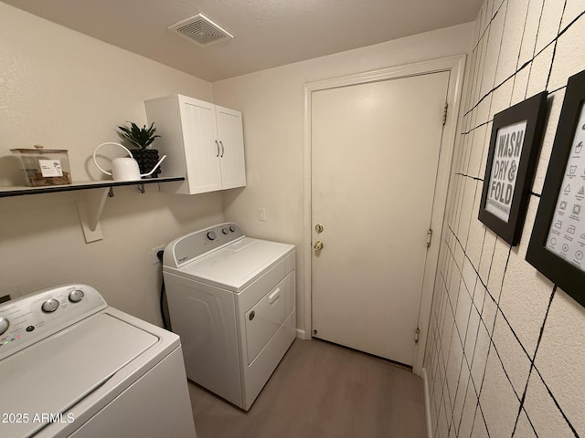 2004 N 108th Dr, Avondale, AZ 85392 - laundry room with cabinet space, separate washer and dryer, and light wood-style floors