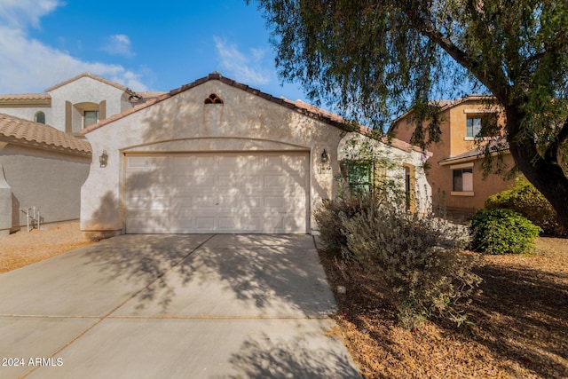 mediterranean / spanish home featuring a garage