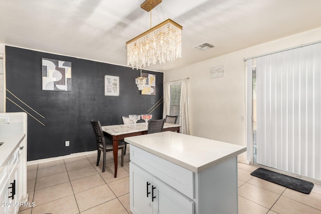 kitchen featuring white cabinets, light tile patterned floors, and a chandelier