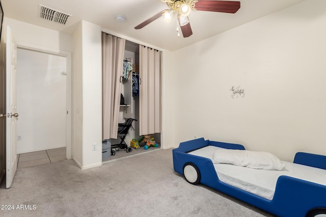 carpeted bedroom with a closet and ceiling fan