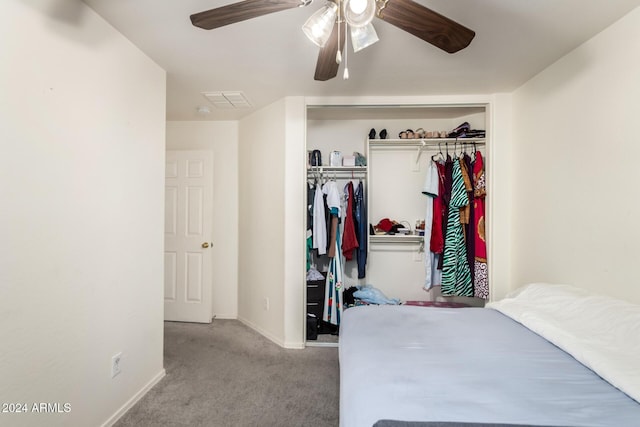 carpeted bedroom with ceiling fan and a closet