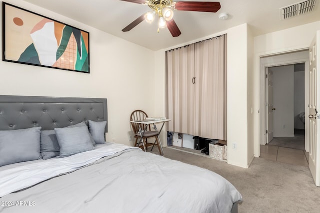 bedroom with light carpet and ceiling fan