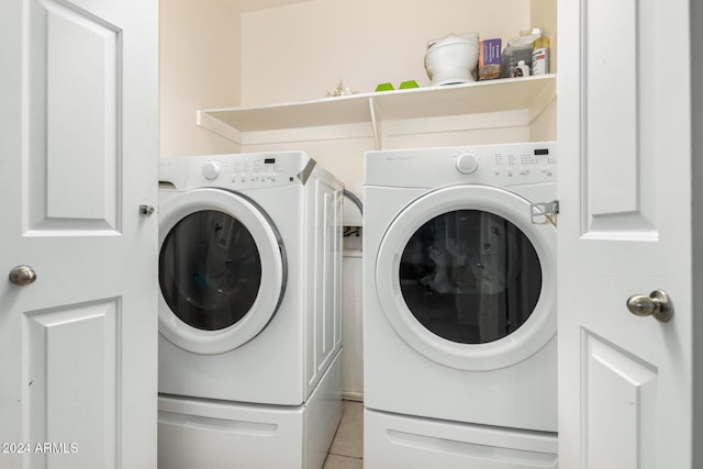 laundry area featuring washing machine and dryer and light tile patterned flooring