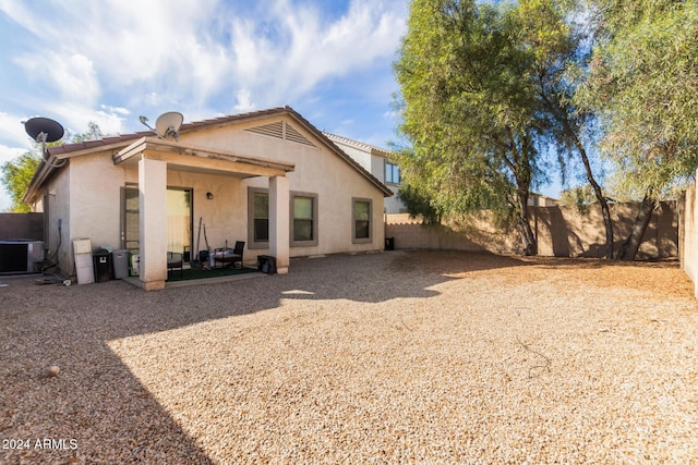 rear view of house featuring central air condition unit