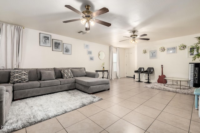 tiled living room with ceiling fan