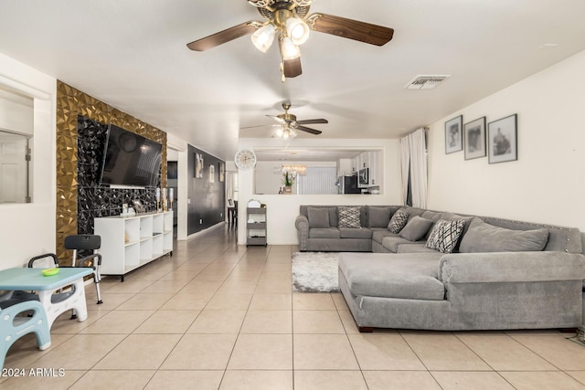 tiled living room with ceiling fan