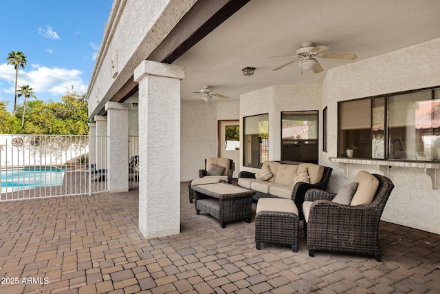 view of patio / terrace with outdoor lounge area, fence, a fenced in pool, and a ceiling fan