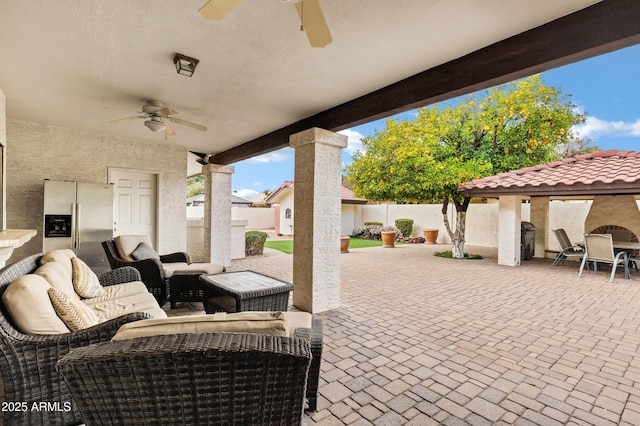 view of patio / terrace with ceiling fan, a fenced backyard, and an outdoor hangout area