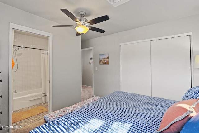 bedroom featuring carpet floors, a closet, ensuite bath, and ceiling fan