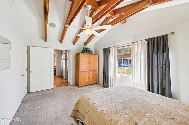 unfurnished bedroom with vaulted ceiling with beams, a ceiling fan, and light colored carpet