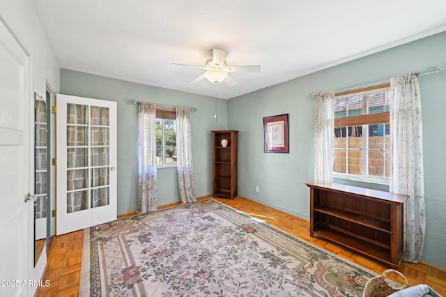 unfurnished room featuring baseboards and a ceiling fan