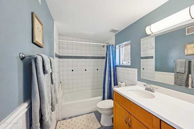 bathroom with shower / bath combination with curtain, visible vents, vanity, and toilet