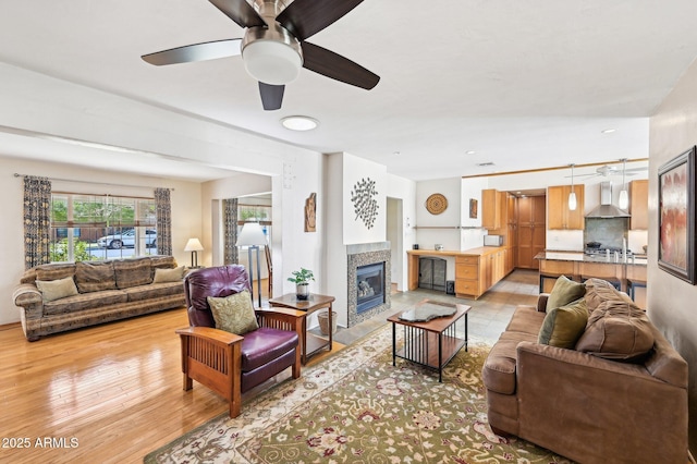 living room featuring light wood finished floors and a tile fireplace